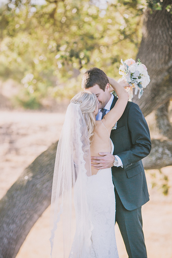 Romantic wedding embrace of a bride and groom outdoors