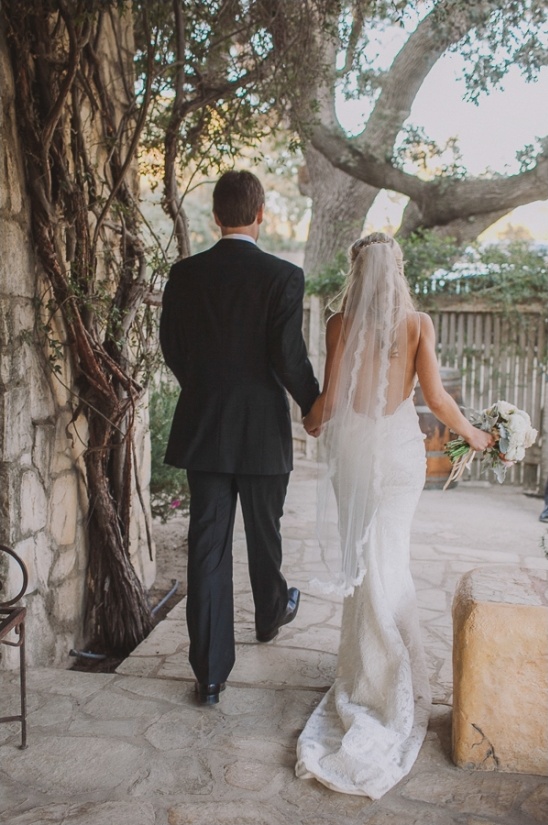 Bride and groom holding hands walking after the wedding ceremony