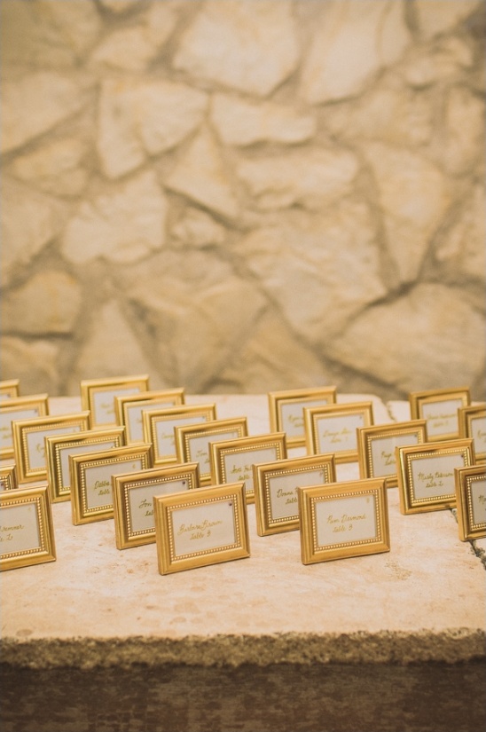 Golden framed place cards arranged for a wedding reception