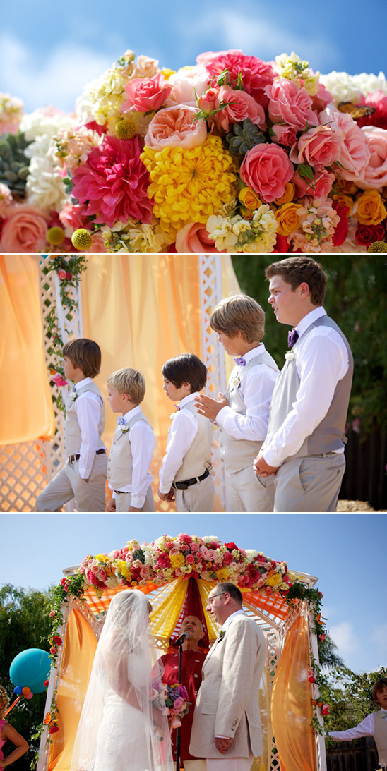 bright floral covered wedding arch