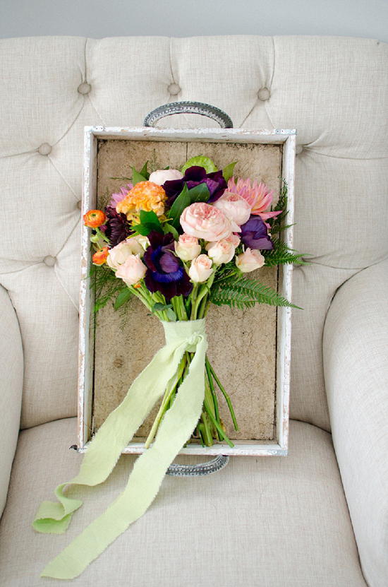 Colorful floral bouquet with green ribbon on tray chair