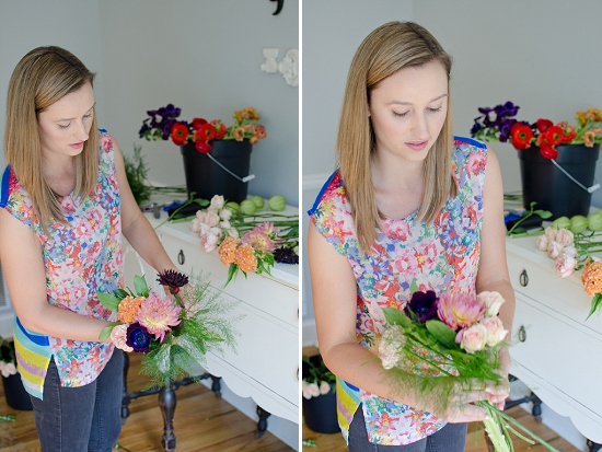 Woman arranging fresh cut flowers at home