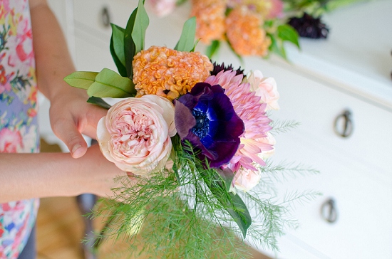 Person holding a colorful bouquet of flowers close up