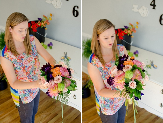 Woman arranging a colorful flower bouquet at home