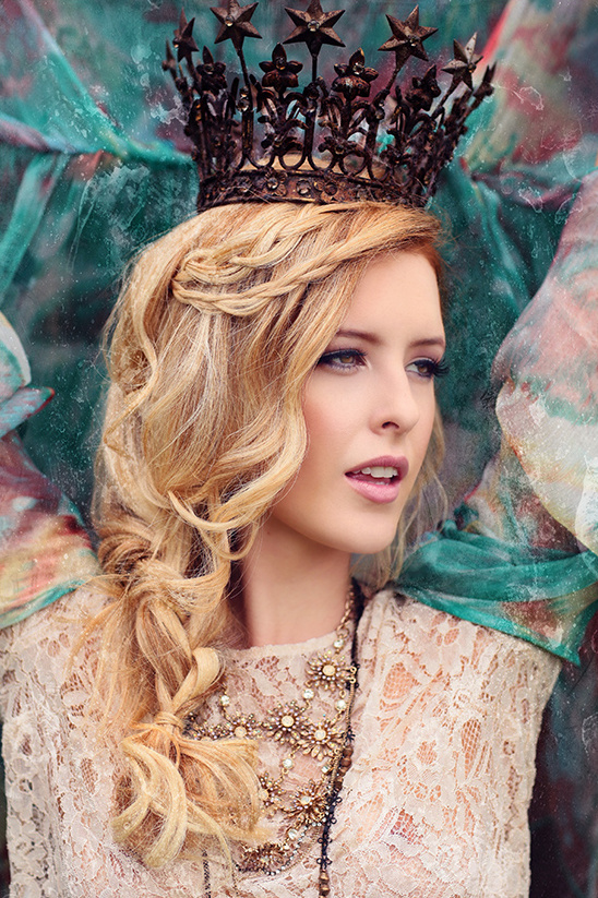 Blonde woman wearing a crown and necklace