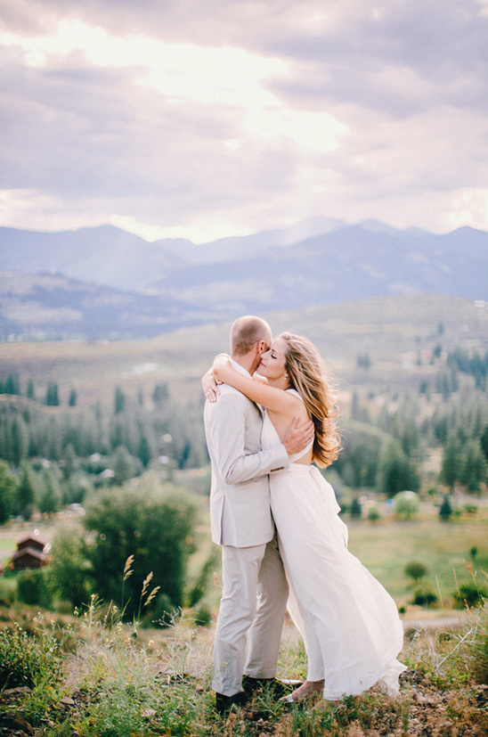 Couple embraces with stunning mountain view, a romantic wedding photo