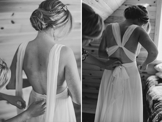 Bride getting help with wedding dress on wedding day