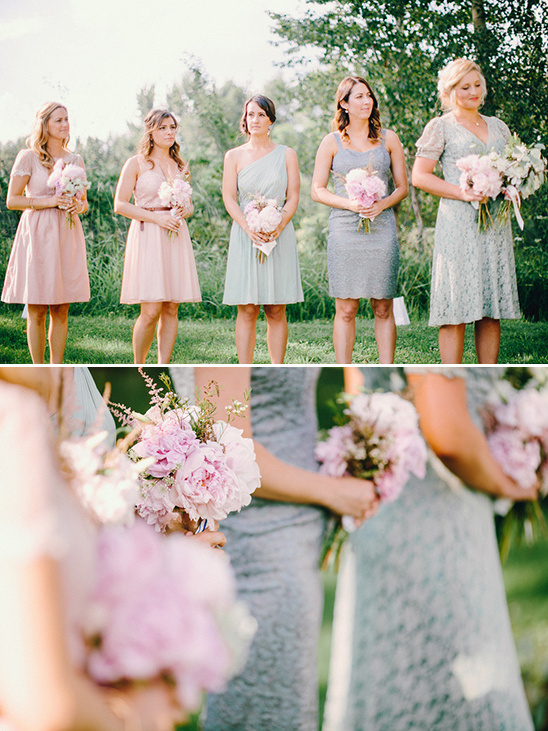Bridesmaids in pastel dresses holding pink bouquets at a wedding