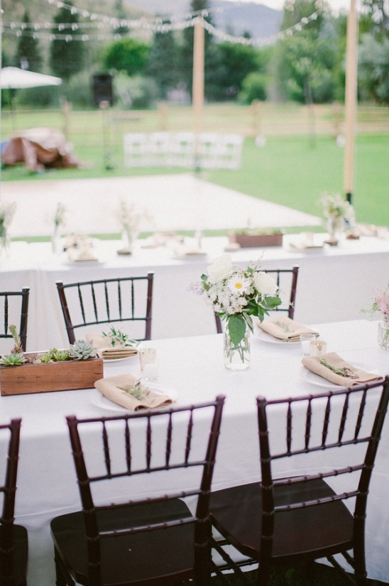 Elegant outdoor wedding reception table setting with flowers