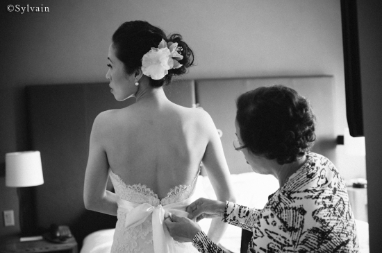 Bride getting dressed with mother