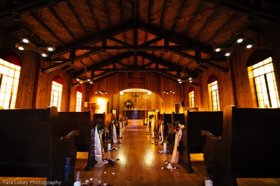Rustic wooden church aisle decorated for a wedding