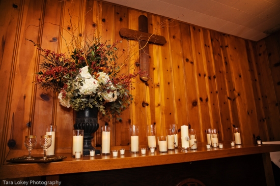 Rustic church decor with cross flowers and candles