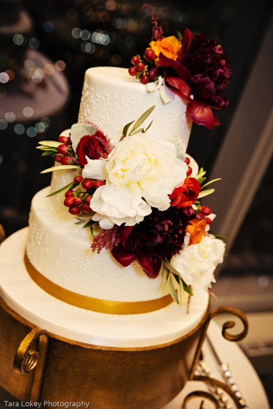 Elegant three-tiered wedding cake adorned with flowers