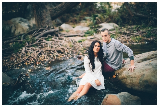 Romantic couple posing by a stream