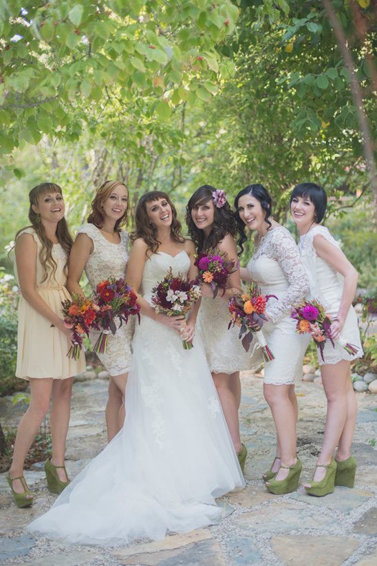 Bride and bridesmaids in white dresses with bouquets