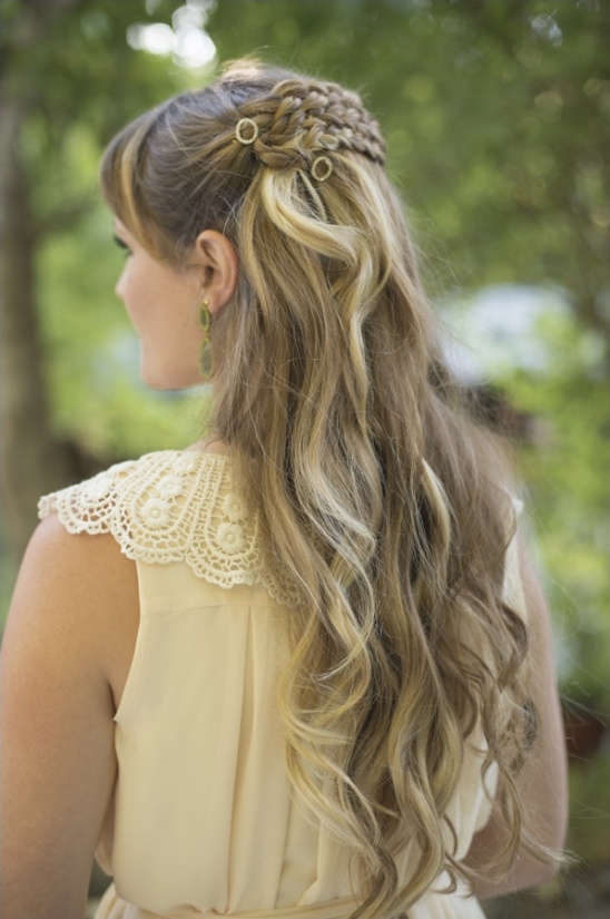 Woman with braided half updo and gold hair rings