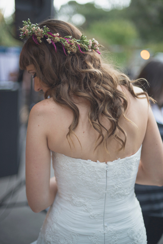 Bride with floral crown and lace dress from behind