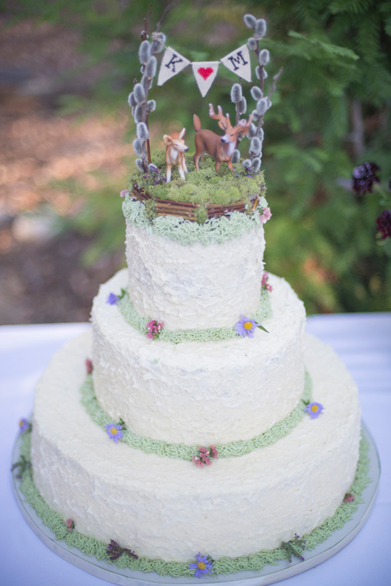 forest wedding cake with mini bunting and deer topper