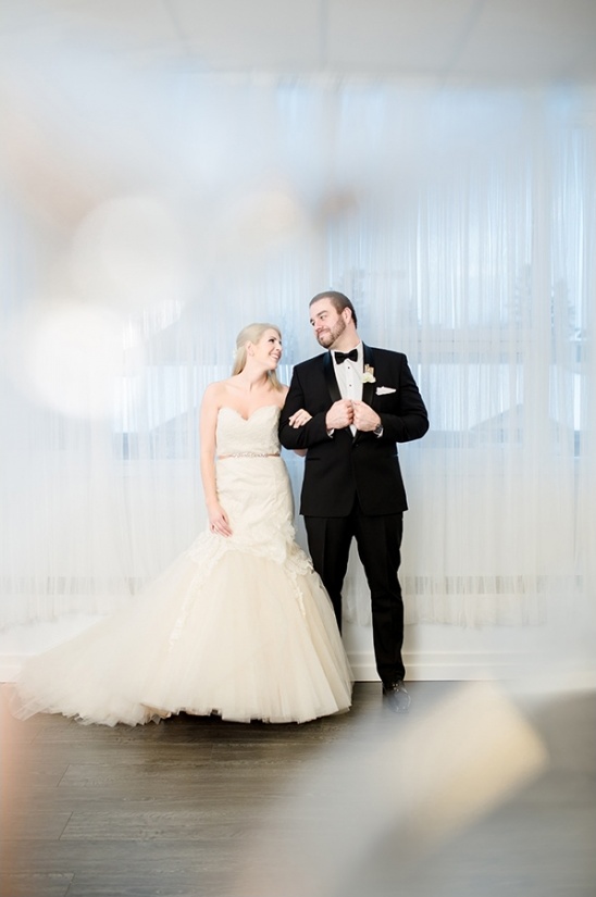 Elegant wedding couple gazing lovingly at each other on their special day