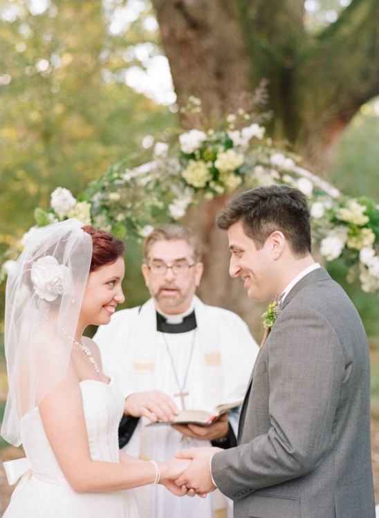 Happy couple exchanging vows at outdoor wedding ceremony