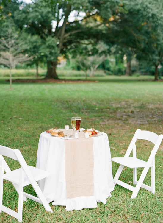 Romantic outdoor table setting with food and drinks