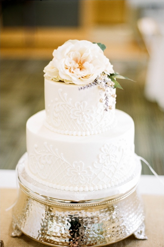 Two tier white wedding cake with floral accents