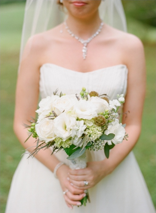 Bride holding elegant white wedding bouquet