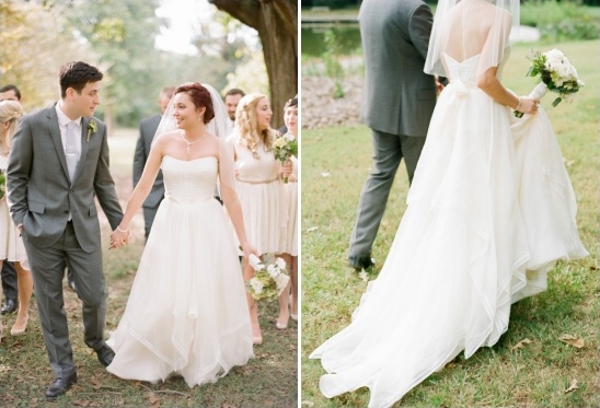 Bride and groom walking down aisle, wedding party in background