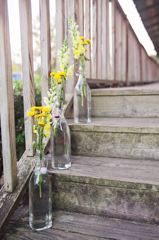 wildflowers in glass bottles brighten up a staircase