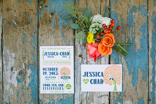 Wedding invitations and flowers on rustic wooden background