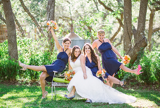 Happy bride and bridesmaids posing for a fun wedding photo