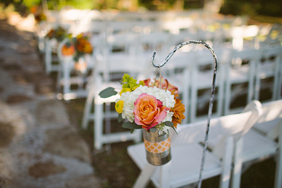 Wedding aisle decor with floral arrangement hanging from hook