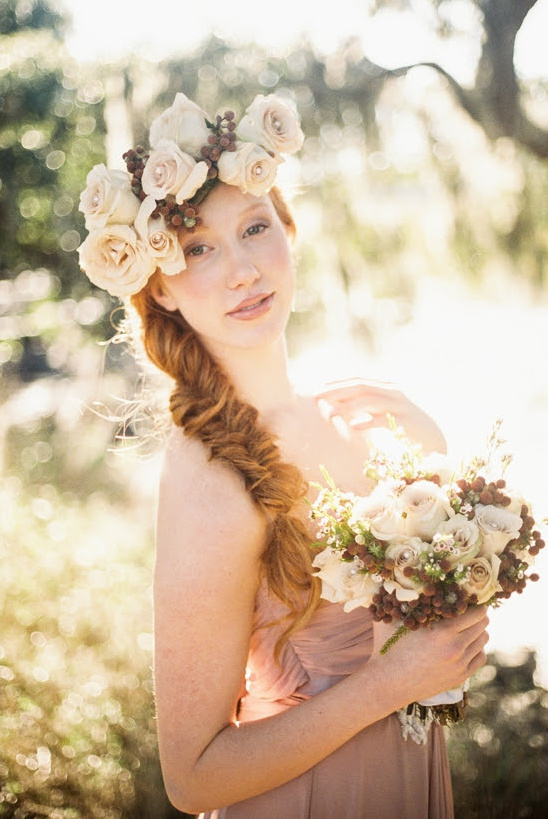 Beautiful bride with flower crown and bouquet, golden sunlight