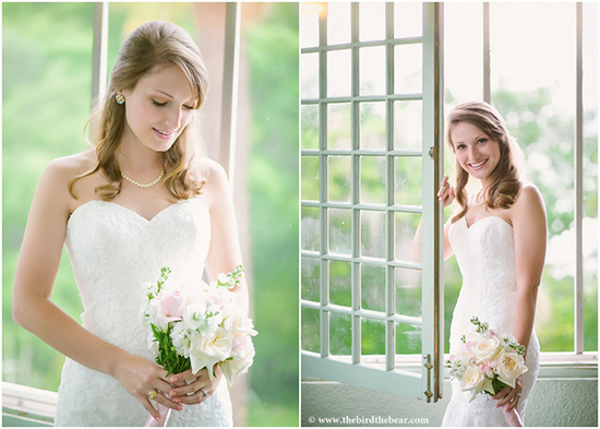 Bride in white dress holding bouquet by a window, smiling
