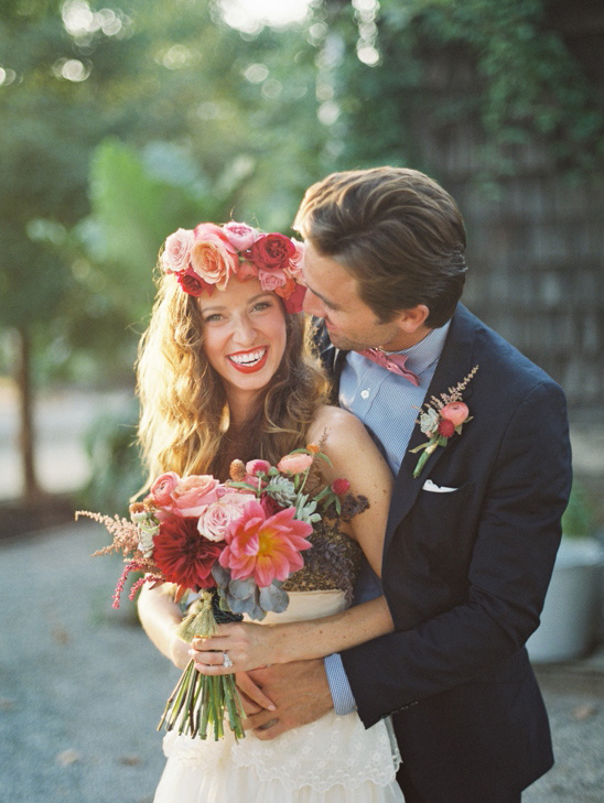 Happy couple on wedding day, bride with floral crown and bouquet