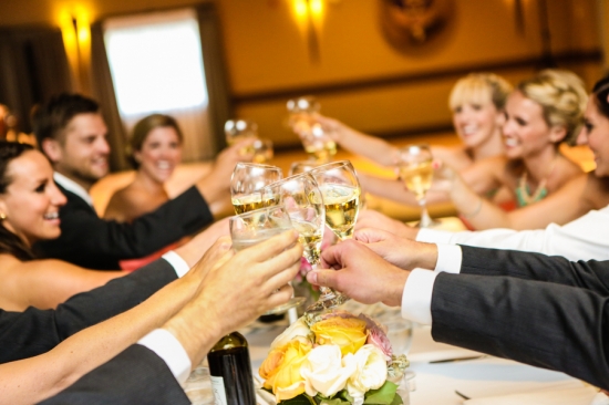 Wedding party toasting with champagne glasses cheers
