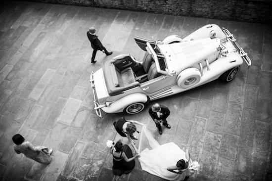 Wedding party with classic car and bride ready for the ceremony