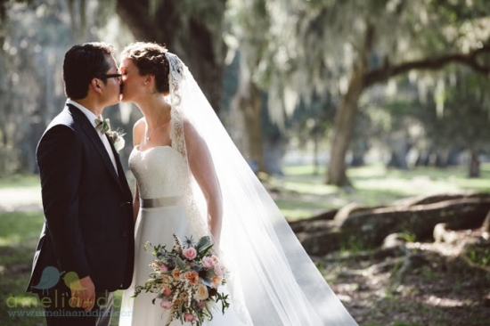 Couple kissing outdoors, wedding day