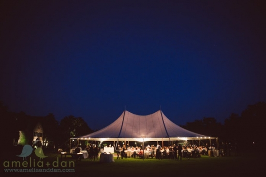 Lighted tent wedding reception at night
