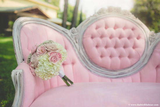 Pink vintage couch with bouquet of flowers for a romantic setting