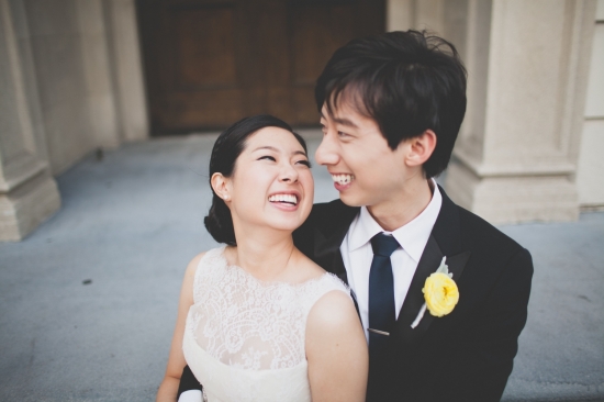 Happy couple on their wedding day smiling at each other