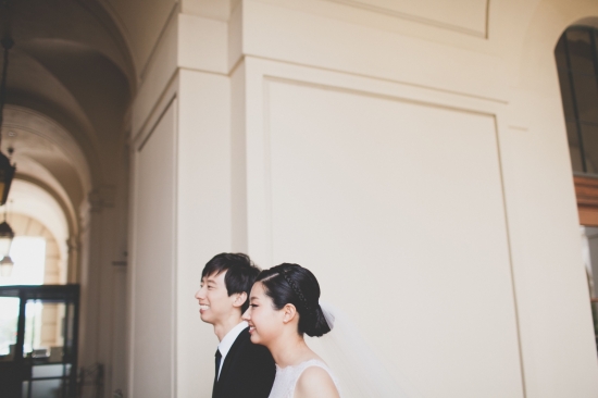 Happy couple smiles in indoor wedding setting