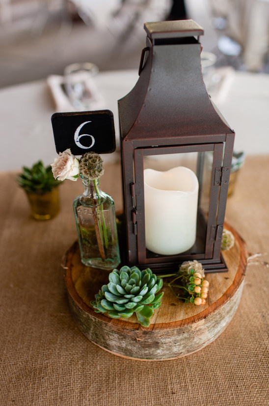 candle lit lantern centerpiece and table number