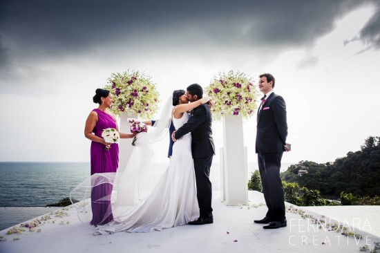 Bride and groom kissing at outdoor wedding ceremony