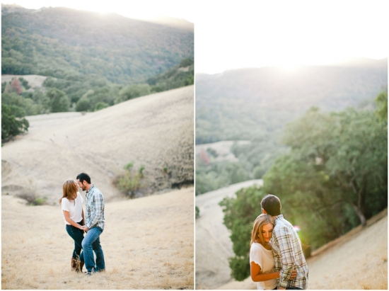 Couple embracing on a hillside with a beautiful mountain view