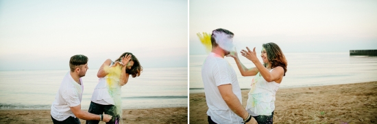 Couple having fun with color powder on the beach