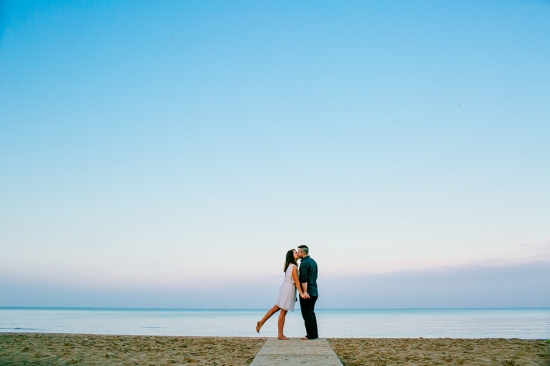 Couple kissing on the beach at sunset