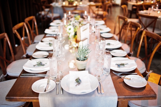Rustic wedding reception table setting with succulents