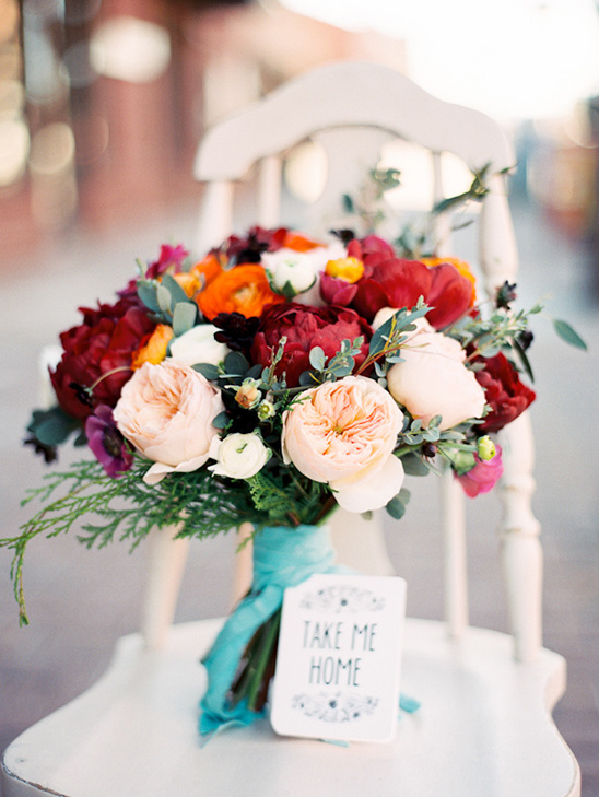 Stunning red and peach wedding bouquet with Take Me Home tag