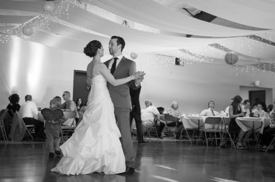 Black and white photo of bride and groom dancing